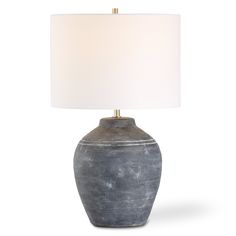 a gray table lamp with a white shade