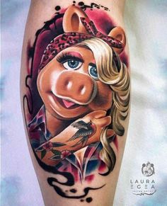 a woman's leg with a pig tattoo on it