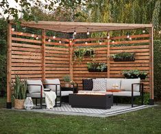 an outdoor living area with furniture and lights