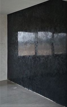 an empty room with black walls and no one in the room or there is something on the floor