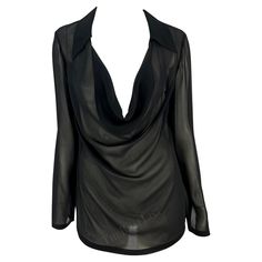 Presenting a fabulous black sheer Gucci blouse, designed by Tom Ford. From the Spring/Summer 1997 collection, this entirely sheer black top features a plunging cowl neckline, a fold-over collar, and lightly belled sleeves. Approximate measurements: Size - 44IT Shoulder to hem: 26.5" Bust: 34 - 42" Waist: 34 - 38" Shoulder to cuff: 25" Underarm to cuff: 18" 72% Rayon Viscose, 28% Silk Black Cowl Neck Top For Night Out, Gucci Black Top For Spring, Evening V-neck Top With Sheer Sleeves, Black Cowl Neck Top For Party, Sheer V-neck Blouse For Party, Formal Black Sheer Blouse, Black Gucci Tops For Winter, Chic Sheer Top For Cocktail, Chic Evening Blouse With Cowl Neck