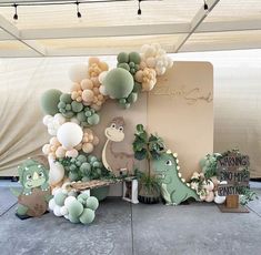 an outdoor display with balloons, plants and animals