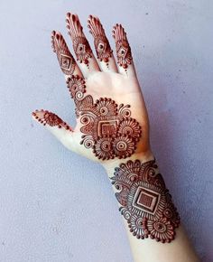 a hand with henna tattoos on it