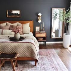 a bed room with a neatly made bed next to a window and a rug on the floor