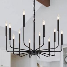 a black chandelier with candles hanging from it