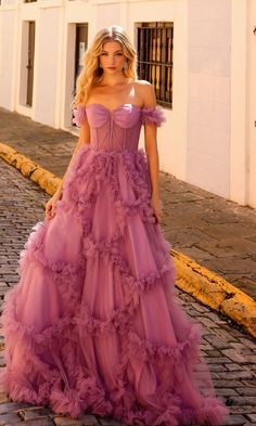 Here's an off-the-shoulder long lavender prom ball gown that is as flirty as it is feminine. With a sheer corset-style bodice that wraps around to the back and ruffled banded sleeves that drape over the upper arms, this long lavender formal dress was made for romance. In misses and some plus sizes, this sweet long evening gown has a fully-lined long skirt with ruffled geometric designs that showcase a real southern feel. A look of romance with a southern feel, this off-the-shoulder long lavender Ballgown Prom Dress Corset, Lavender Formal Dress, Prom Dress With Corset, Ruffle Tulle Dress, Long Ball Gown, Sheer Corset, Dusty Lavender, Corset Boning, Off Shoulder Gown