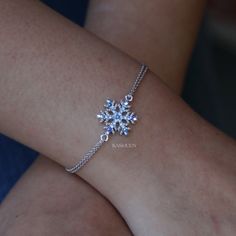 "PERFECT CHRISTMAS GIFT FOR LADY / GIRL You are getting a dainty Snowflake charm original rhodium plated bracelet attached to two fine cable original rhodium plated chains. Charm size is 5/8\" wide X 11/16\" high (16mm X 17mm) Color (Standard Swarovski Color Names): Light Sapphire, Sapphire AB The bracelet measures 7\" long (17.8cm) with 2\" extension chain (5cm). Prices are in US$. For shipping policies and other important information, click on \"profile\" on the right. See an item that you lik Elsa Stuff, Ice Spirit, Jewelry Snow, Snow Jewelry, Ice Bracelet, Winter Angel, Theatre Production, Snowflake Bracelet, Snowflake Jewelry