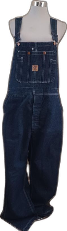 Utility Denim Bottoms With Bib Front, Utility Denim Bib Front Bottoms, Cotton Straight Leg Overalls With Button Closure, Straight Leg Cotton Overalls With Button Closure, Retro Denim Jumpsuit With Bib Front, Retro Cotton Dark Wash Shortalls, Retro Denim Bib Front Jumpsuit, Vintage Cotton Denim Jumpsuit With Button Closure, Retro Dark Wash Cotton Shortalls