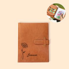 a brown leather notebook with the word bonnie on it and a flower drawn in black ink