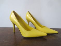 Absolutely killer Frederick's of Hollywood glossy, bright canary yellow sky high stiletto heels in really nice vintage condition! There's actually very little signs of wear inside and out, but as pictured, there's a small scratch on the outside of the right heel. Otherwise no major flaws to note. Gold Frederick's of Hollywood stamp on the insoles, black print inside reads: 8M, 64249, All Man Made Materials, Made in China Labeled as a size 8M, these seem to run pretty true to size. I'm typically Vintage Yellow Pointed Toe Heels, Retro Yellow Heels For Party, Yellow Retro Heels For Party, Retro Yellow High Heels, Yellow Retro High Heels, Heels 4 Inch, Yellow Sky, Womens Pumps, Fredericks Of Hollywood