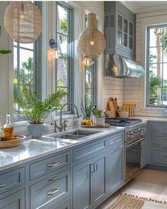 a kitchen filled with lots of counter top space next to a sink and stovetop oven