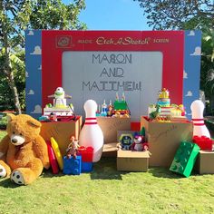 a teddy bear sitting in front of a sign that says mabon and matheh