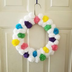 a colorful wreath hanging on the front door