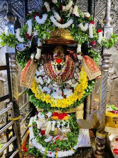 the idol is decorated with flowers and garlands