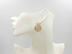 These are pair of beautiful camellia rose earrings. They are made with golden plated over brass flower shaped filigree pendants. The flower is available in two different golden color. The gold color is in a deep gold; and light gold color is in a light gold tone. The earrings measure about 31mm (1.25 inches) from the top of the ear wires to the bottom of the flower. They are perfect for many occasions, gift giving or as a little treat for yourself. Your earrings will presented in a jewelry gift Gold Flower-shaped Hoop Earrings For Wedding, Gold Rose Design Earrings For Wedding, Gold Hoop Earrings With Flower Charm For Wedding, Gold Earrings With Rose Design For Gift, Gold Earrings With Rose Design As Gift, Flower Shaped Brass Wedding Earrings, Elegant Rose Earrings With Ear Wire, Elegant Rose Dangle Earrings, Brass Flower-shaped Earrings For Wedding