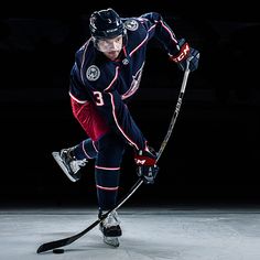 an ice hockey player in action on the ice with his stick and helmet, ready to play