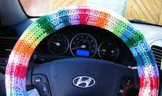 the steering wheel cover is decorated with multicolored yarn