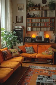 a living room with orange couches and bookshelves