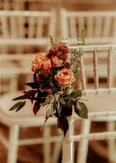 a bouquet of flowers sitting on top of a white chair