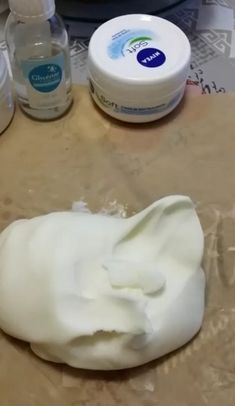 a table topped with whipped cream next to bottles of toothpaste and other items