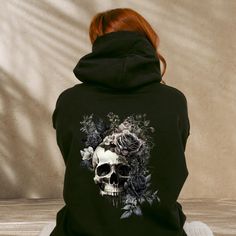 Floral Skull Hoodie, Bloom Skull Back Print Hoody, Whimsigoth Skull Hoodie, Goblincore Shirt, Dark Cottagecore Sweatshirt, Gothic Clothing This Classic Unisex Adult Hoodie features: * Double fabric hood * Self coloured cords * Kangaroo pouch pocket * Ribbed cuffs and hem * Twin needle stitching detailing * 80% Ringspun Cotton 20% Polyester ** SIZING ** * Please check size chart on the listing photos. Chest measurement is from armpit to armpit, not around the torso. To find the right size, we rec Halloween Skull Sweatshirt In Black, Black Skull Sweatshirt For Halloween, Black Skull Hoodie For Fall, Black Halloween Sweatshirt With Skull, Black Halloween Skull Sweatshirt, Gothic Cotton Hoodie For Alternative Fashion, Halloween Hoodie With Skull Print, Halloween Hoodie Sweatshirt For Alternative Fashion, Punk Halloween Hoodie With Skull Print