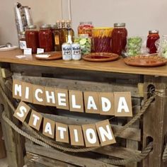 a table topped with lots of food and condiments on top of wooden pallets