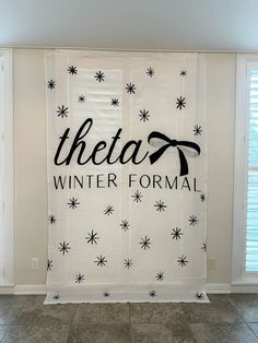 there is a white curtain with the words theater and snowflakes hanging on it