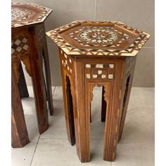 two wooden tables with mosaic designs on them