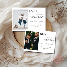 two wedding announcement cards sitting on top of a table