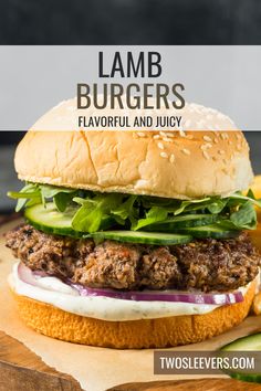 a hamburger sitting on top of a wooden cutting board with lettuce and cheese