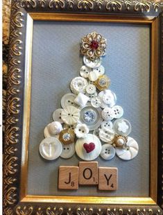 a christmas tree made out of buttons in a frame