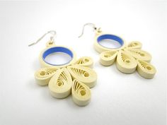 two pairs of wooden earrings with blue hoops on white background, side by side