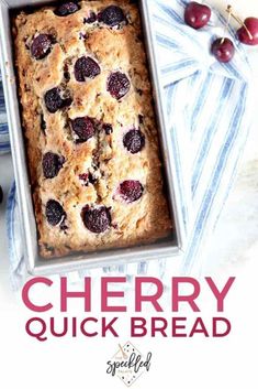 a loaf of cherry quick bread in a pan with fresh cherries on the side