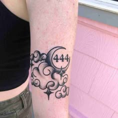 a woman's arm with a clock and clouds tattoo on the left side of her body