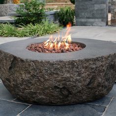 a fire pit sitting on top of a stone walkway