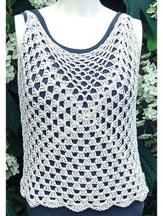 a white crocheted top on a mannequin