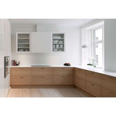 a kitchen with white walls and wooden floors