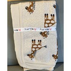 two blankets with giraffes and hearts on them