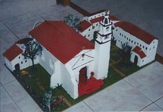 a model of a white church with red roof