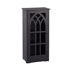 a tall black cabinet with an arched window on the top and bottom shelf, in front of a white background