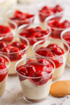 small cups filled with desserts sitting on top of a table