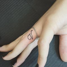 a woman's hand with a small tattoo on it