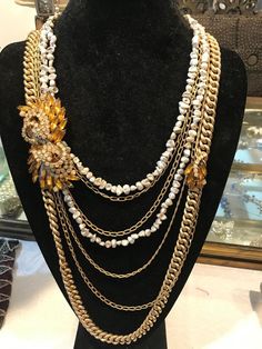 This vintage necklace was created in my workshop. It is reminiscent of the old glamour of Hollywood during its Golden Age. This is a wonderful necklace that can be worn anywhere. There are seven strands of necklaces, two are made with authentic pearls. The others are gold chains varying in size. There are two topaz brooches from the 1940's each on the opposite ends of the necklace making it asymmetrical. All pieces are vintage and put together make a gorgeous necklace. Measurements: The longest Luxury Silver Multi-strand Pearl Necklace, Vintage Gold Necklaces With High Luster, Vintage Gold Necklace With High Luster, Vintage Gold Pearl Necklace For Evening, Evening Multi-strand Pearl Necklace, Elegant Multi-strand Beaded Chain Necklace, Multi-strand Pearl Necklace For Formal Occasions, Luxury Multi-strand Pearl Chain Jewelry, Formal Costume Multi-strand Pearl Necklace