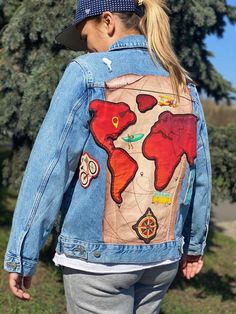 In front of you a work of art that hides power, uniqueness and individuality.  Custom jacket is not just an ordinary jacket, it is a masterpiece of craftsmanship, which is created thanks to our creativity and visionary ideas. The picture shows a personalized jacket for a female traveler. Everything was painted by hand : continents and pictures. Then hardened with special foam and hand sewn on. The map itself was painted directly on the denim jacket base. You can also choose a different base jack Shirt Painting, Painted Clothing, Personalized Jacket, Travel Jacket, Painted Jacket, Music Painting, T Shirt Painting