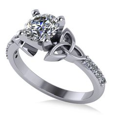 a white gold ring with a diamond in the center and an intricate knot around it