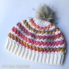 a crocheted hat with a pom - pom on top