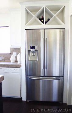 a stainless steel refrigerator in a white kitchen