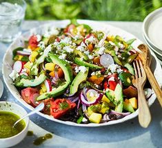 a salad with avocado, tomatoes and other vegetables