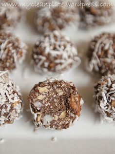 chocolate truffles with coconut flakes are on a white plate