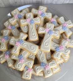 decorated cookies arranged in the shape of crosses on a plate